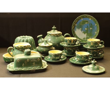 A Soufflenheim pottery tea and breakfast set, in green with white polka dots, teapot, butter dish, kugelhopf cake mould, cups