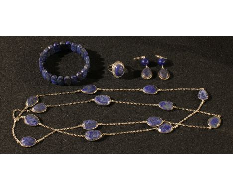 A pair of sterling silver and lapis lazuli droplet earrings, marked 925; an unmarked metal ring set with a single polished la