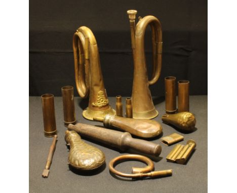 A brass and copper bugle, QC RA badge affixed, no mouthpeice; another similar; six post war cartridge cases, two shot flasks,