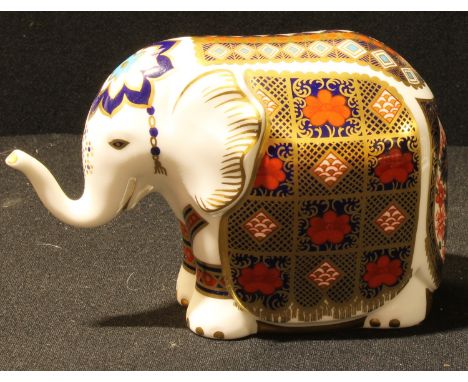 A Royal Crown Derby paperweight, Elephant, printed in the Imari palette, trunk raised, gold stopper, 10cm high, first quality