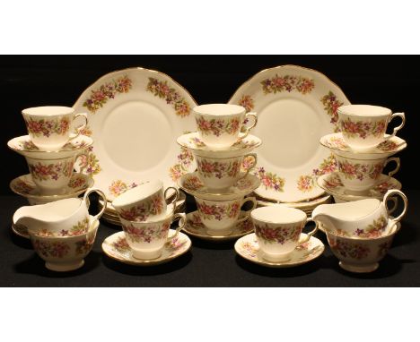 A Colclough Honeysuckle pattern tea set, twelve cups, eleven saucers, twelve tea plates, two sugar bowls, two milk jugs, pair