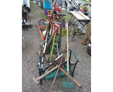 A large quantity of garden tools, a hose on a reel, garden kneeler, etc.