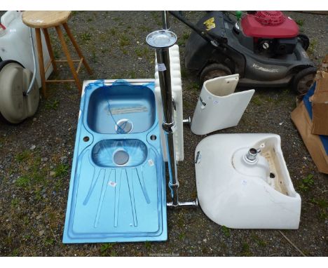 A chrome bathroom radiator, a stainless steel sink and a hand basin.