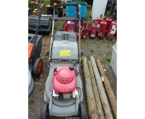 A "Honda" lawn mower with grass box and rear roller, (air cleaner missing off carburetor), good compression.