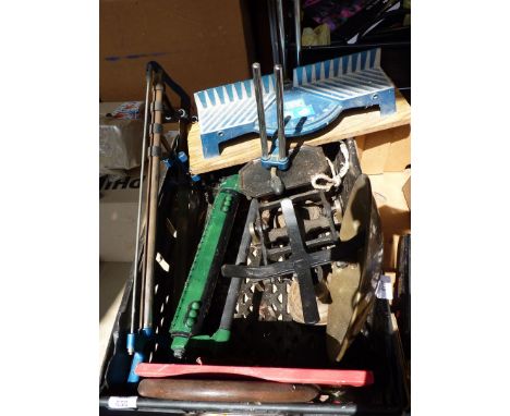 A mitre saw, balance scales, a garden sprinkler and a large weight.