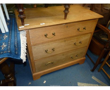 A light oak chest of four drawers 34" wide x 19" depth x 32" high.