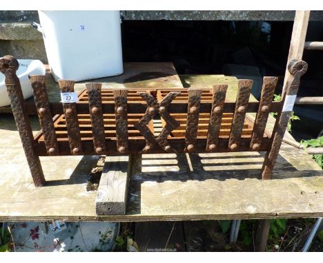 A cast iron fire grate, 23 1/4" wide x 14" deep.