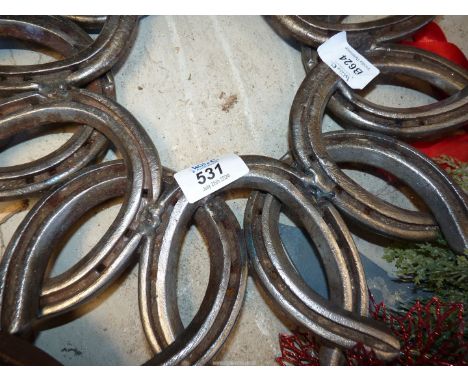 Christmas light decorations and horseshoe sculpture.