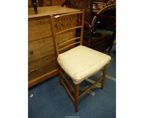 A mahogany commode arm chair with cane back and two bamboo cane chair.