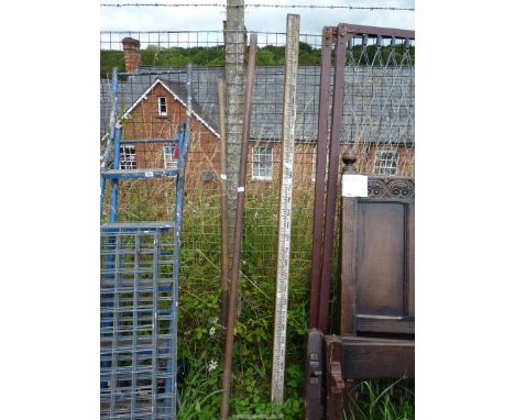 Surveyors measuring poles, plus a heavy duty crow bar 77" long and a long handled muck fork.