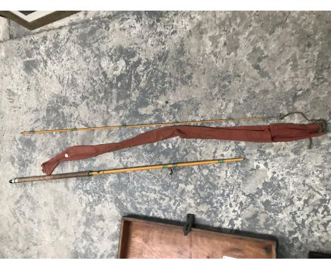 A VINTAGE TWO PIECE FISHING ROD IN BROWN CLOTH CASE 