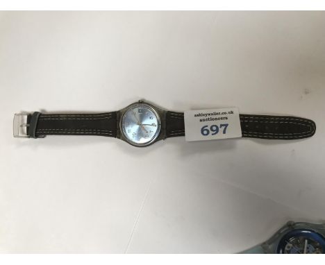 A SWATCH WATCH WITH A BLUE FACE AND A BROWN SUEDE STRAP. 