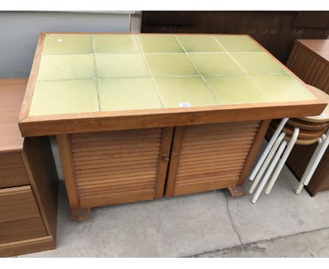 A TILE TOP PINE KITCHEN TABLE WITH TWO LOUVRE DOORS 