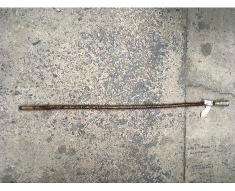 A WALKING STICK WITH ELABORATE METAL HANDLE 