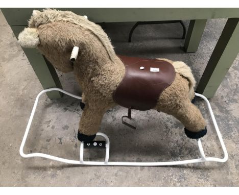 A VINTAGE FURRY ROCKING HORSE ON METAL ROCKERS 