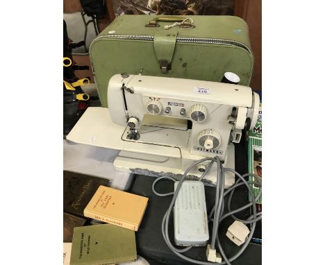 A VINTAGE CASED 'HOFMANN' SEWING MACHINE WITH PEDAL 