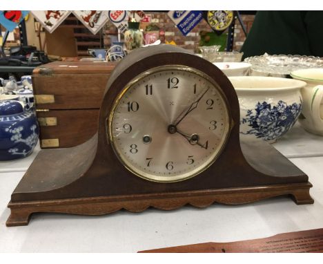 A NAPOLEONS HAT MAHOGANY CASED MANTLE CLOCK- WORKING AT TIME OF CATALOGING 