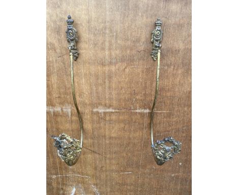 A PAIR OF VINTAGE BRASS CURTAIN TIE BACKS 