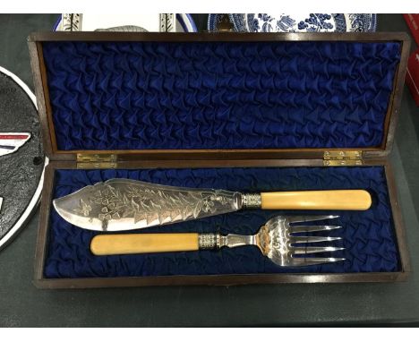 A KNIFE AND FORK FISH SERVING SET CASED IN AN OAK BOX 