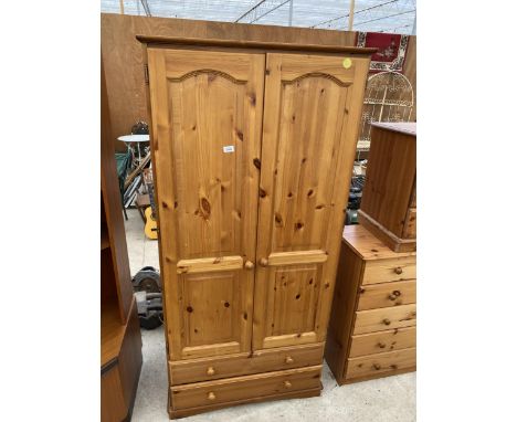 A MODERN TWO DOOR PINE WARDROBE WITH TWO DRAWERS TO THE BASE, 33" WIDE 