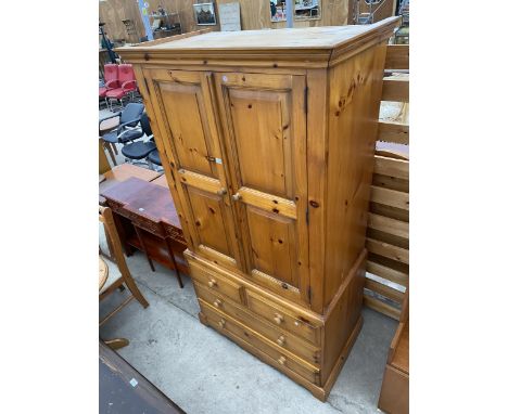 A MODERN PINE TWO DOOR WARDROBE WITH FOUR DRAWERS TO THE BASE, 40" WIDE 