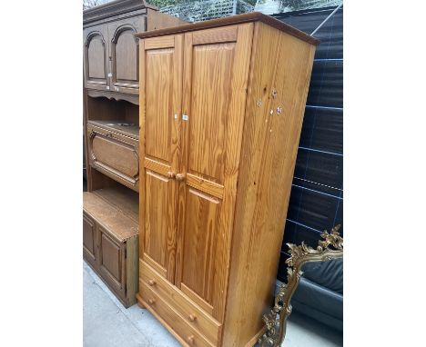 A MODERN PINE TWO DOOR WARDROBE WITH TWO DRAWERS TO THE BASE, 34" WIDE 