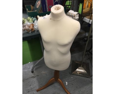 A MANNEQUIN ON A WOODEN TRIPOD STAND 