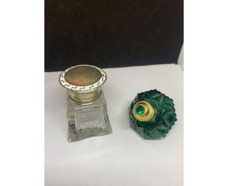 TWO VINTAGE PERFUME BOTTLES - ONE CUT GLASS WITH A HALLMARKED BIRMINGHAM SILVER AND ENAMEL TOP AND AN INTERNAL STOPPER AND A 