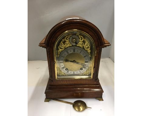 A GEORGE III STYLE OAK CASED BRACKET CLOCK WITH DOMED TOP REEDED COLUMNS EMBOSSED BRASS FACE AND BEVELL EDGE GLASS DOOR BY W 