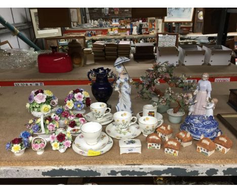 A QUANTITY OF CERAMIC ITEMS TO INCLUDE, CHINA CUPS AND SAUCERS, HERB COTTAGES, FIGURINES, CHINA POSIES, ETC 