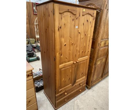 A MODERN TWO DOOR PINE WARDROBE WITH TWO DRAWERS TO THE BASE, 33" WIDE 