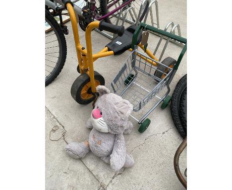 A CHILDRENS TRIKE, A CHILDS TROLLEY AND A TEDDY BEAR 