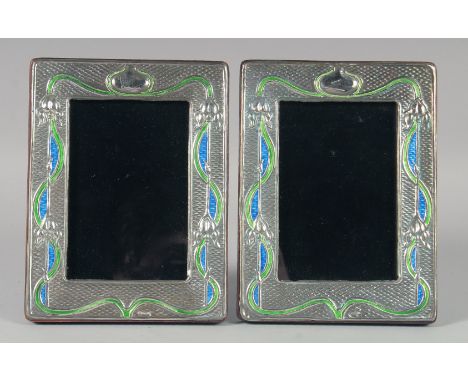 A PAIR OF SILVER AND ENAMEL PHOTOGRAPH FRAMES. 19.5cm high