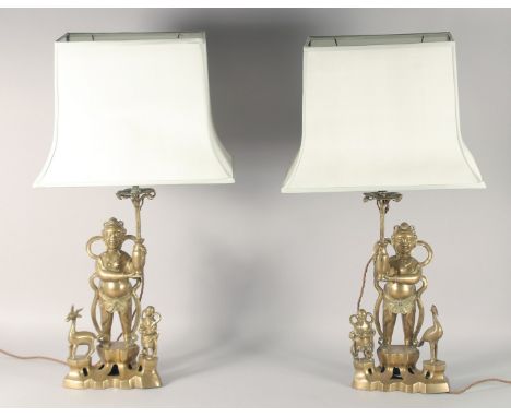 A PAIR OF CHINESE BRASS FIGURAL LAMPS, with shades, lamp / base 51.5cm high.