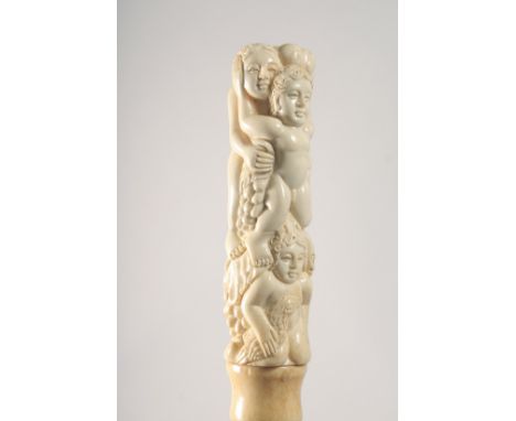 A WALKING STICK WITH CARVED BONE HANDLE as figures and grapes.