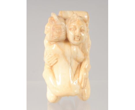 A CHINESE CARVED BONE EROTIC NETSUKE. 4.5cm