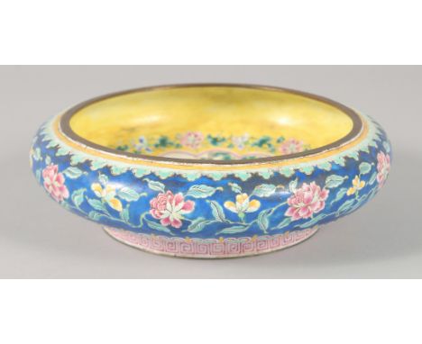 A 19TH CENTURY CHINESE CANTON ENAMEL BOWL, the interior decorated with a central panel depicting female figures in a garden, 