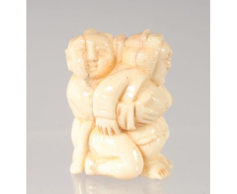 A CHINESE CARVED BONE EROTIC NETSUKE. 4.5cm.