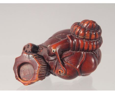 A CARVED WOOD NETSUKE modelled as a dragon 5cm long.