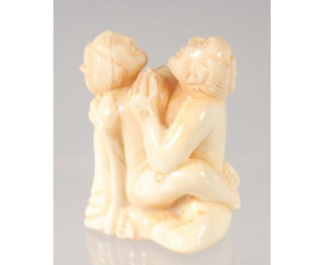 A CHINESE CARVED BONE EROTIC NETSUKE. 4.5cm.