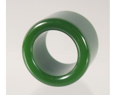 A DARK GREEN JADE ARCHERS RING. 3.5cm diameter.