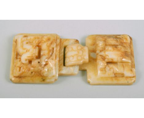 A CHINESE CARVED JADE BUCKLE, with two locking pieces (2).