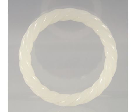 A CHINESE OPAQUE JADE TWISTED BANGLE. 8cm diameter
