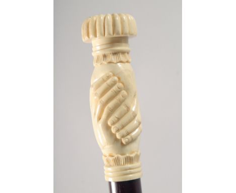 A WALKING STICK WITH CARVED BONE HANDLE modelled as clasped hands.