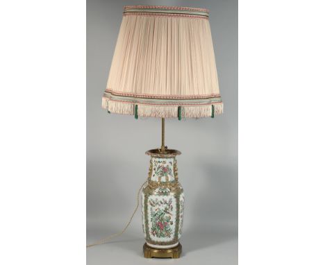 A CHINESE CANTON FAMILLE ROSE PORCELAIN VASE / LAMP, with large shade and mounted to a metal base, decorated with panels of b