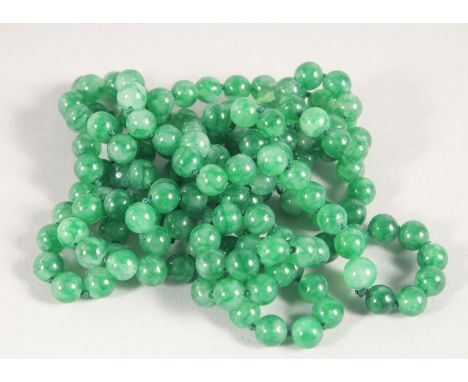 A JADE BEAD NECKLACE. 136cm long 