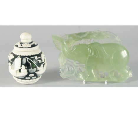 A SMALL CHINESE GREEN GLASS JAR with raised decoration of boating scenes and figures, bearing two character marks, 9cm high, 