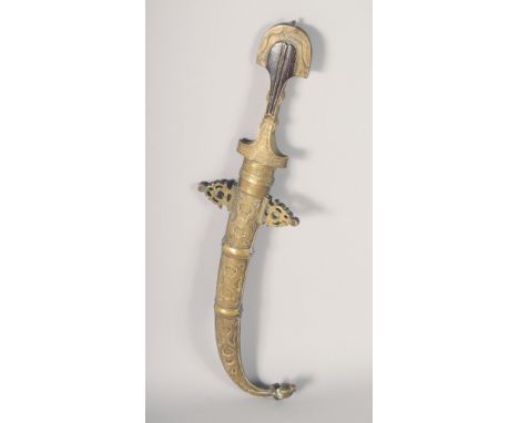 AN ISLAMIC DAGGER, with brass and possibly silver scabbard, 42cm long.