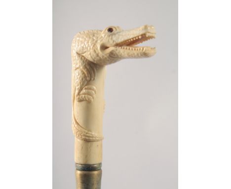 A WALKING STICK WITH CARVED BONE HANDLE as an alligator.