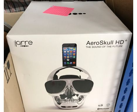 A Jarre AeroSkull HD+ speaker in chrome effect, together with a box of sundry items to include various notebooks decorated wi